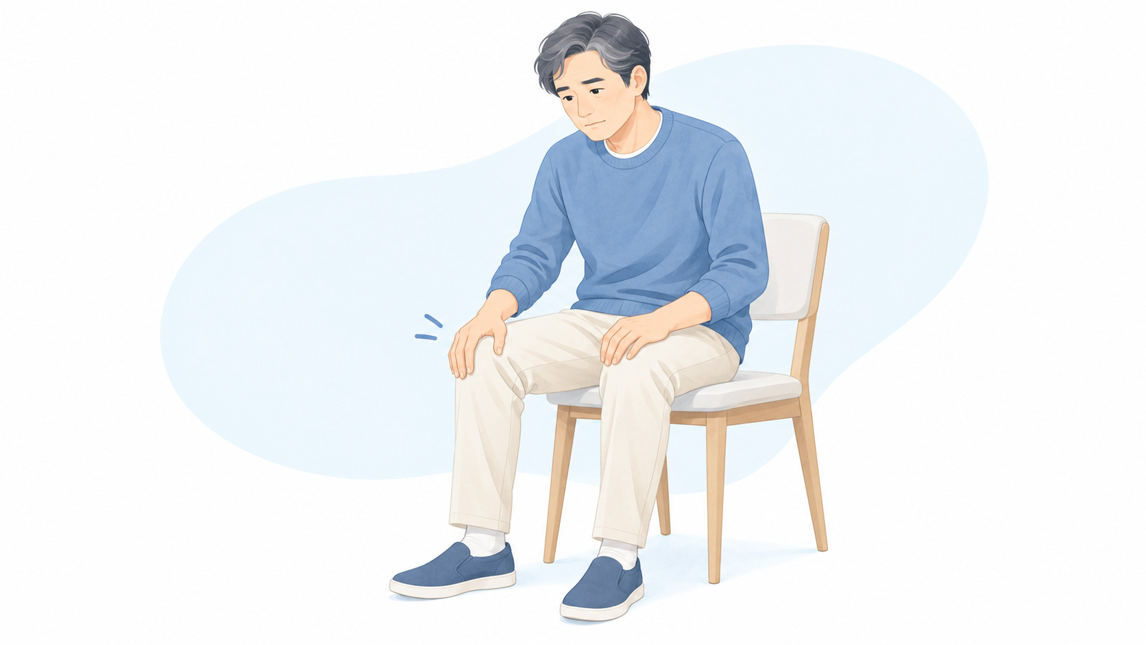 膝の不快感を感じて椅子に座る人